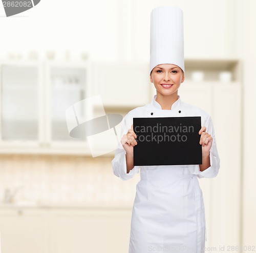 Image of smiling female chef with black blank paper