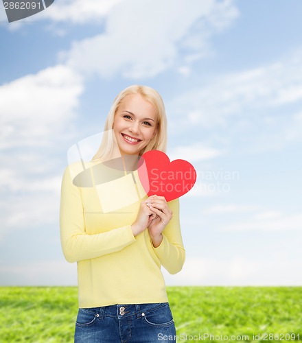 Image of smiling woman with red heart