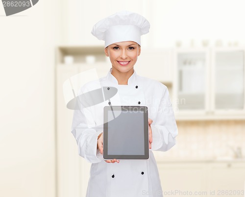 Image of smiling female chef with tablet pc blank screen