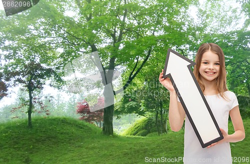 Image of smiling little girl with blank arrow pointing up