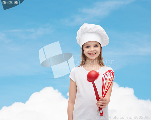 Image of smiling girl in cook hat with ladle and whisk