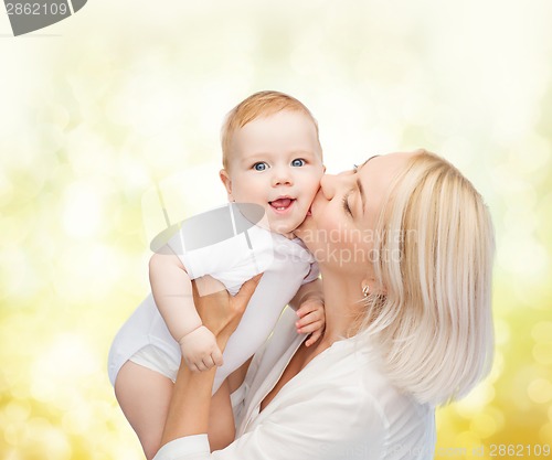 Image of happy mother kissing smiling baby