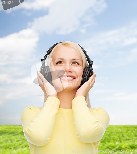 Image of smiling young woman with headphones