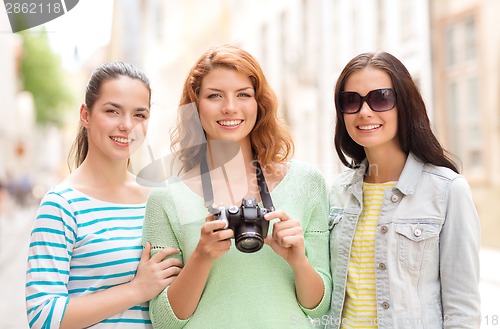 Image of smiling teenage girls with camera