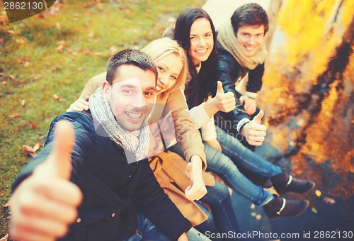 Image of group of friends having fun in autumn park