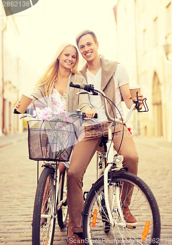 Image of couple with bicycles in the city