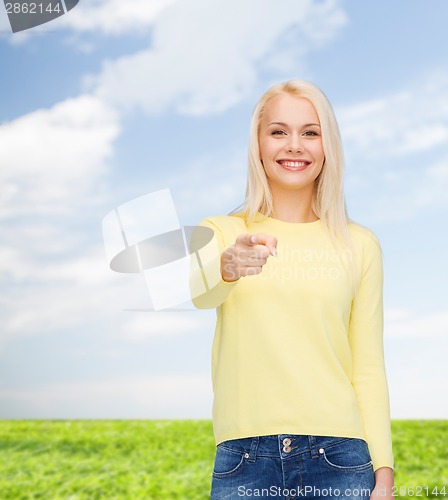 Image of smiling woman pointing finger at you