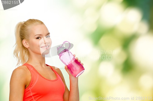 Image of smiling sporty woman with water bottle