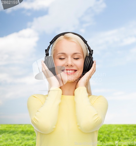 Image of smiling young woman with headphones
