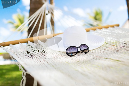 Image of picture of hammock with white hat and sunglasses