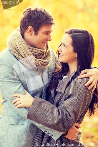 Image of romantic couple kissing in the autumn park