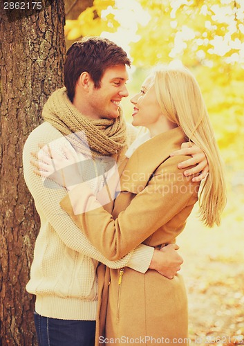 Image of romantic couple kissing in the autumn park