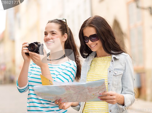 Image of smiling teenage girls with map