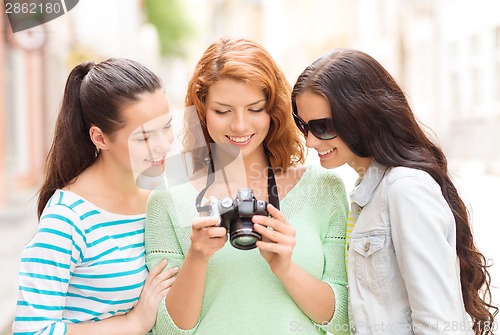 Image of smiling teenage girls with camera