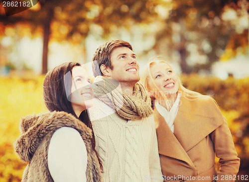 Image of group of friends having fun in autumn park