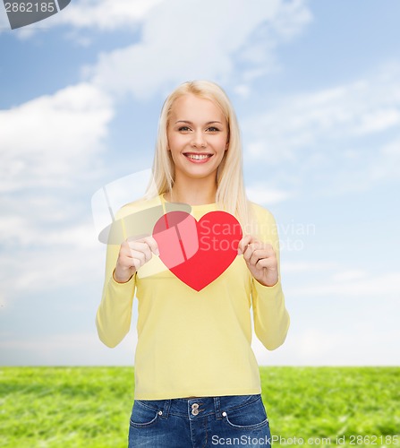 Image of smiling woman with red heart