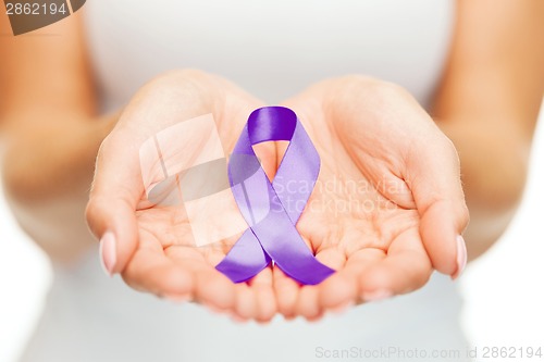 Image of hands holding purple awareness ribbon