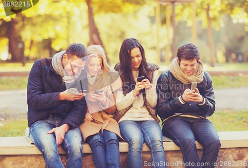 Image of group of friends having fun in autumn park