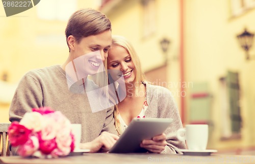 Image of couple with tablet pc in cafe