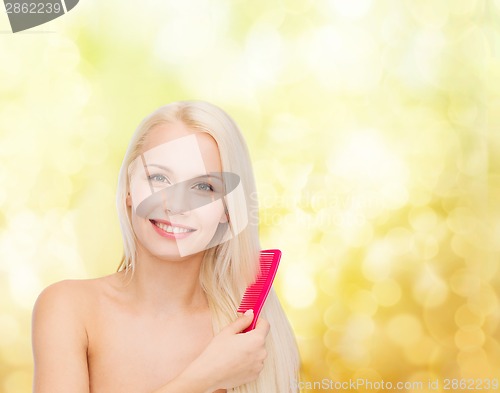 Image of smiling woman with hair brush