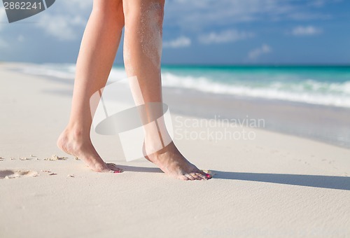 Image of closeup of woman legs on sea shore