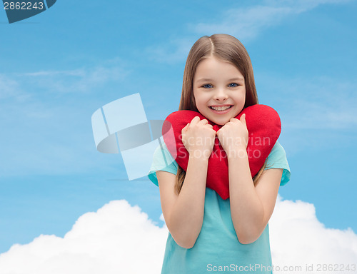 Image of smiling little girl with red heart