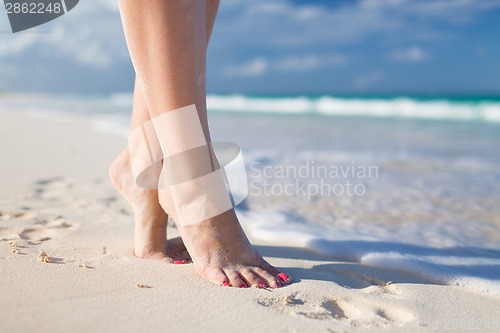 Image of closeup of woman legs on sea shore