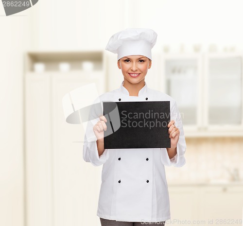 Image of smiling female chef with black blank paper