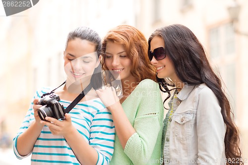 Image of smiling teenage girls with camera