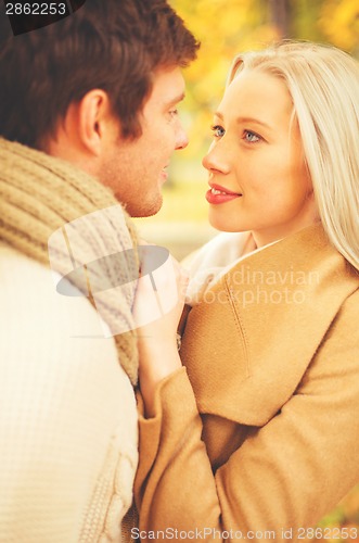 Image of romantic couple kissing in the autumn park