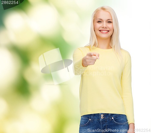 Image of smiling woman pointing finger at you