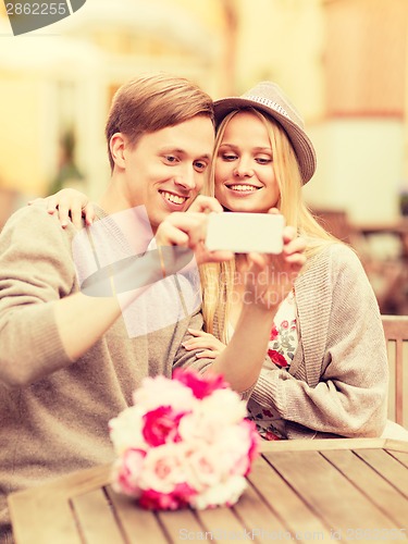 Image of couple taking picture with smartphone