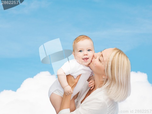 Image of happy mother kissing smiling baby