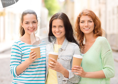 Image of smiling teenage girls with on street