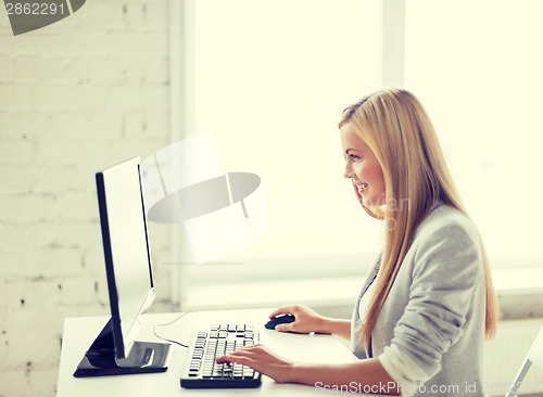 Image of businesswoman with computer in office
