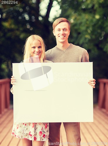 Image of romantic couple with blank white board