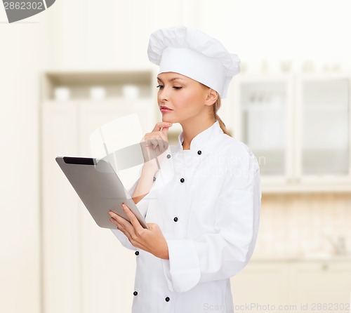 Image of smiling female chef with tablet pc computer