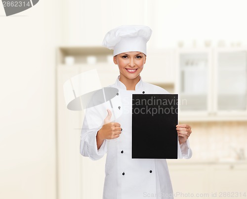 Image of smiling female chef with black blank paper