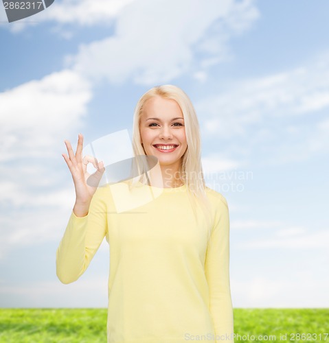 Image of young businesswoman showing ok sign