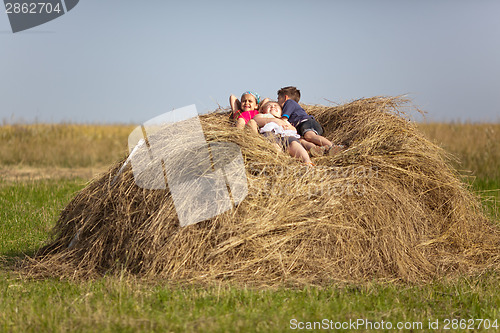 Image of Children resting in the hay