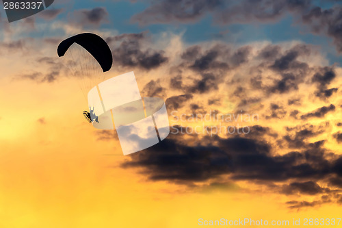 Image of unidentified skydiver, parachutist on blue sky