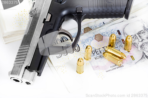 Image of gun with bullet on czech banknotes