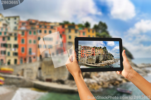Image of Riomaggiore Woman taking pictures on a tablet