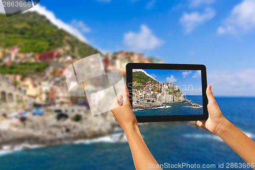 Image of Girl taking pictures on a tablet in Manorola