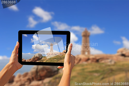 Image of Woman taking pictures on a tablet lighthouse