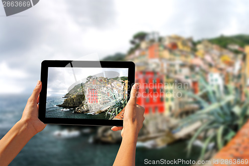 Image of Girl taking pictures on a tablet in Riomaggiore
