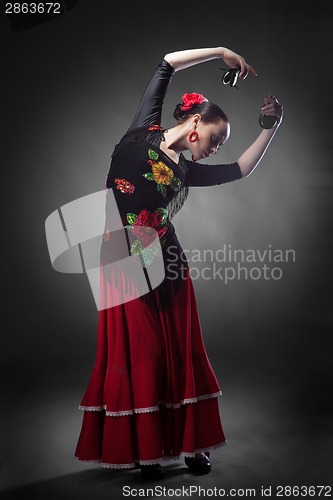 Image of woman dancing flamenco with castanets