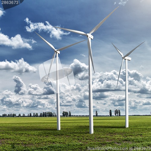 Image of Wind generators turbines on summer landscape