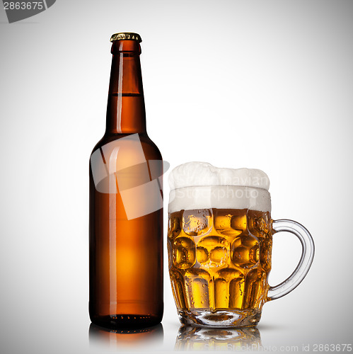 Image of Beer in glass and bottle on white