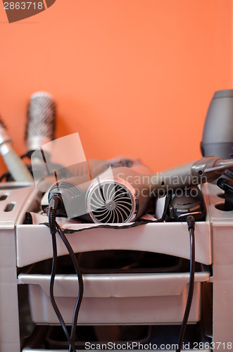 Image of hairdressing accessories  lies in the gray shelf 